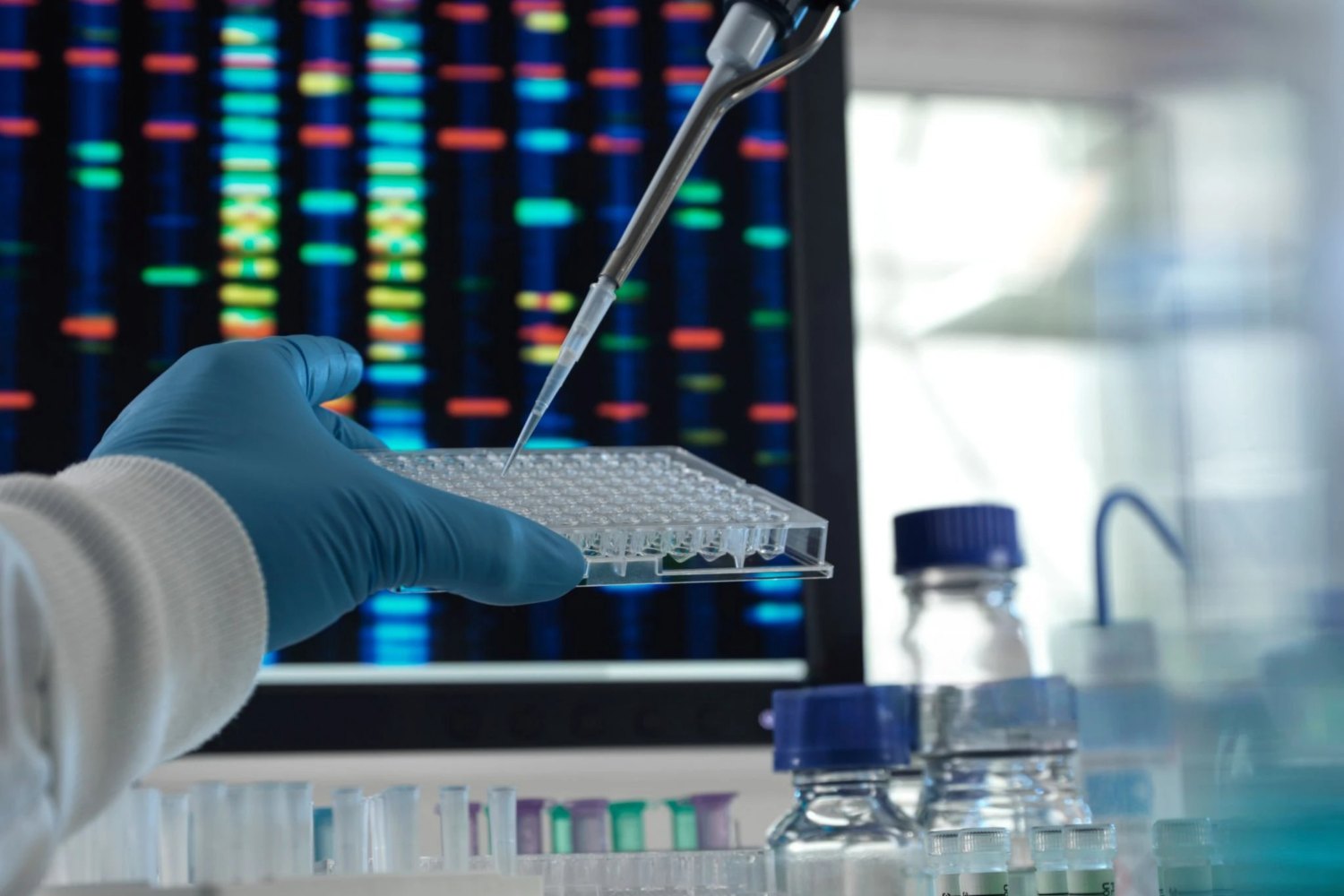 Scientist using a pipette in a genetics laboratory